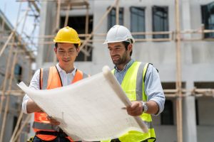 Asian,Male,Civil,Engineer,And,Caucasian,Male,Architect,Wears,Safety