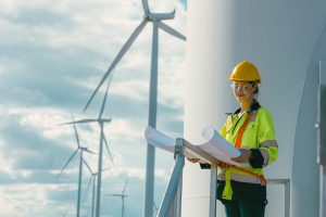 Female,Engineer,Working,Outdoor,With,Safety,At,Wind,Turbines,Clean